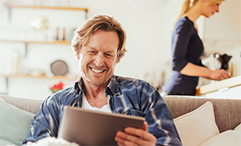 man using tablet in living room