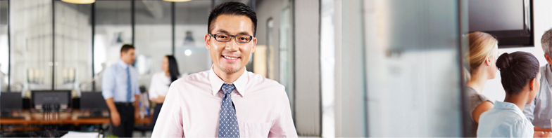 man with glasses and tie standing in office