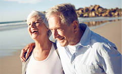 older couple walking along beach