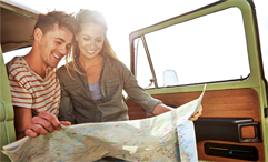 couple reading roadmap sitting in car