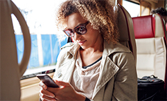 woman on train using phone