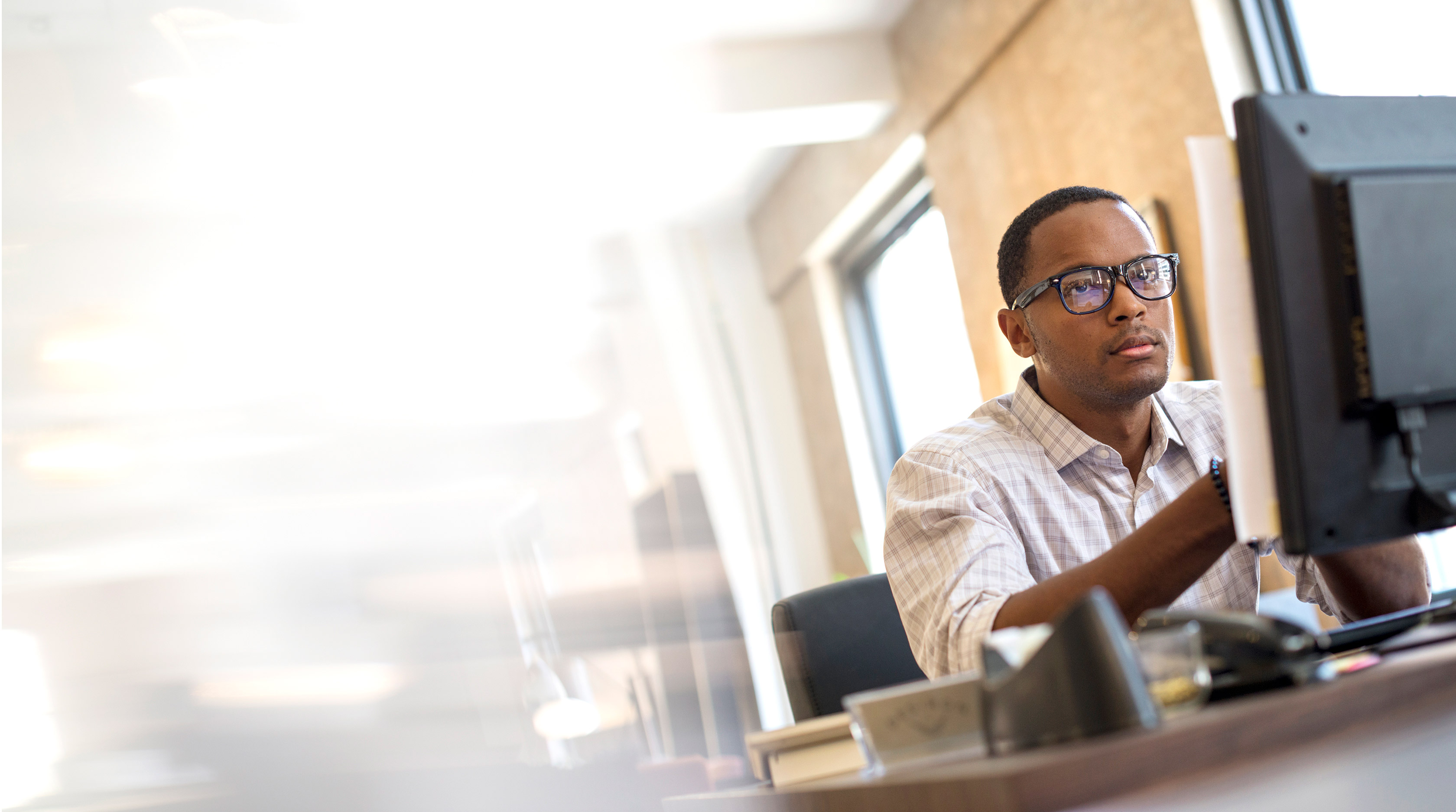man with glasses at desk