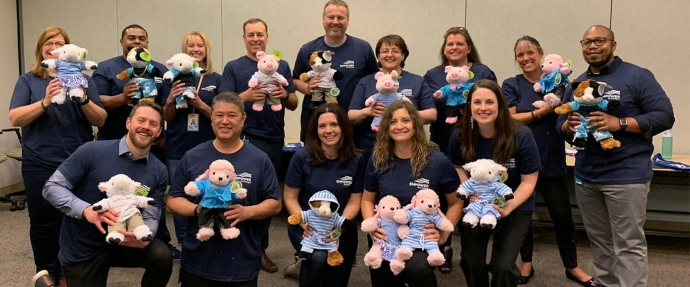 Empower associates display stuffed animals for donation