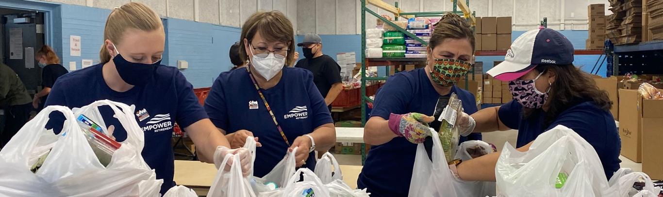 Empower associates pack food into bags for donation to food bank