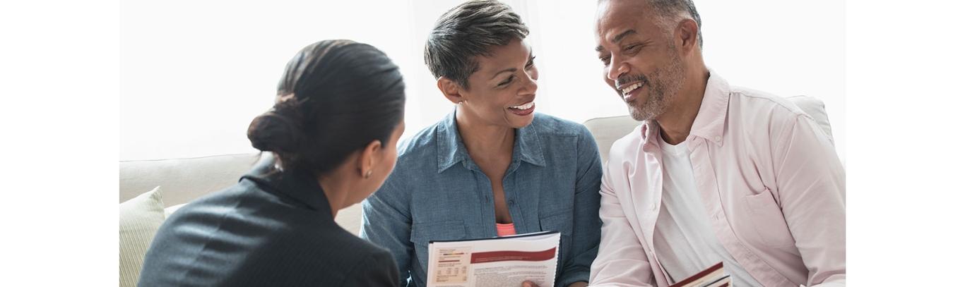 A financial advisor meeting with African American couple to plan retirement savings