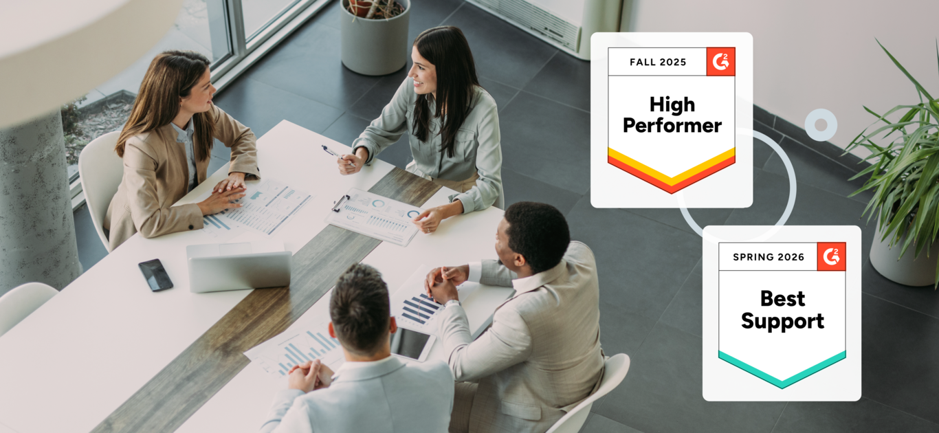 Company employees sit at a conference table in discussion. Graphics: Fall 2025 High Performer. Spring 2025 Best Support.