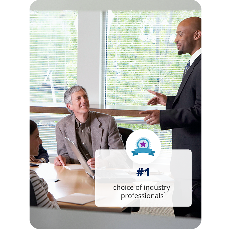 A man stands speaking to a conference room of employees. #1 choice of industry professionals.
