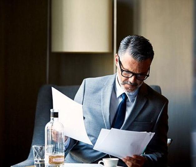 Businessman in a suit looking over paperwork