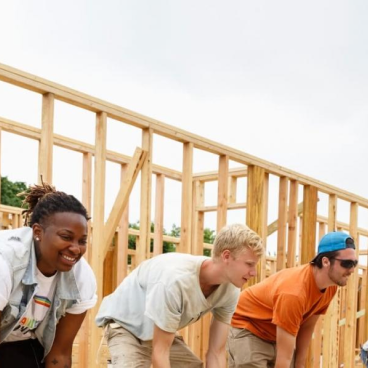 people building house framing outside