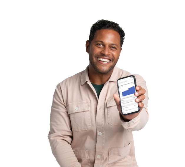 A man smiles as he holds up mobile phone