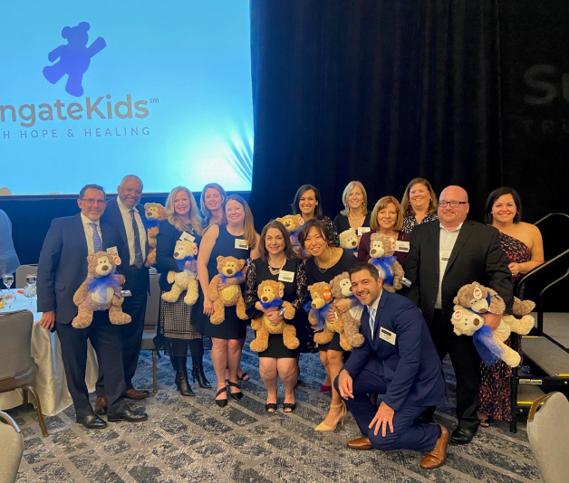 Empower employees posing with stuffed animals