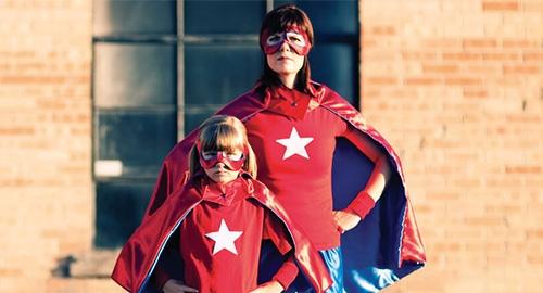 Mother and daughter dressed in superhero costumes
