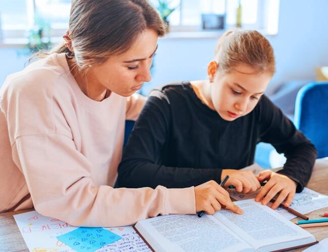 A mother and daughter work on homework