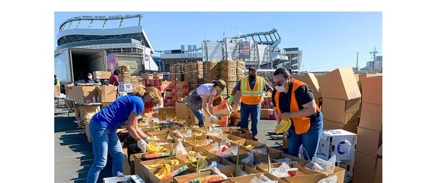 Empower associates sort food donations at Empower Field at Mile High