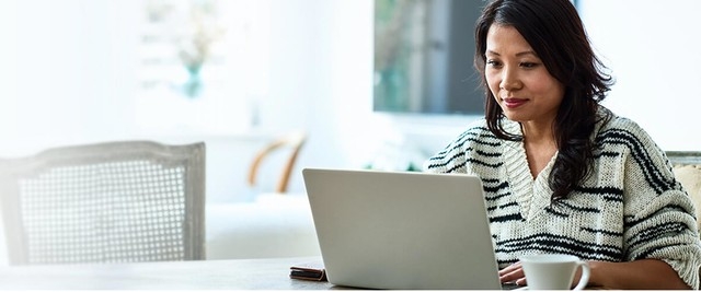 woman using laptop computer to review finances
