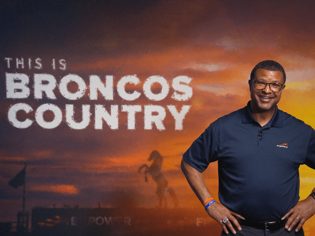 Steve Atwater stands in front of banner that reads Broncos Country