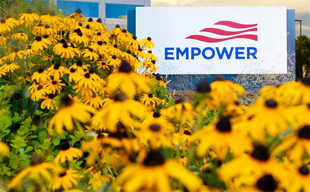 View of Empower headquarters in Colorado, yellow flowers next to sign
