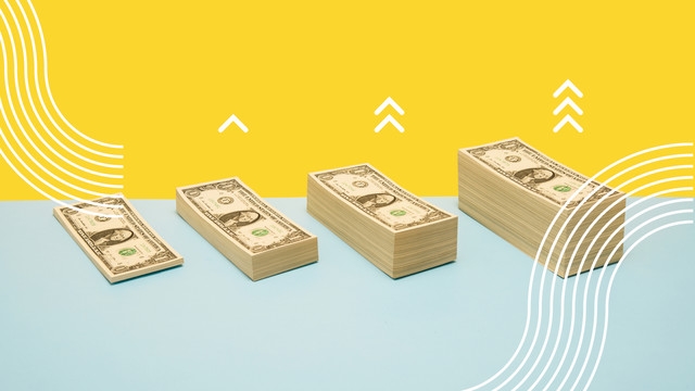 stacked dollar bills on yellow and blue backdrop