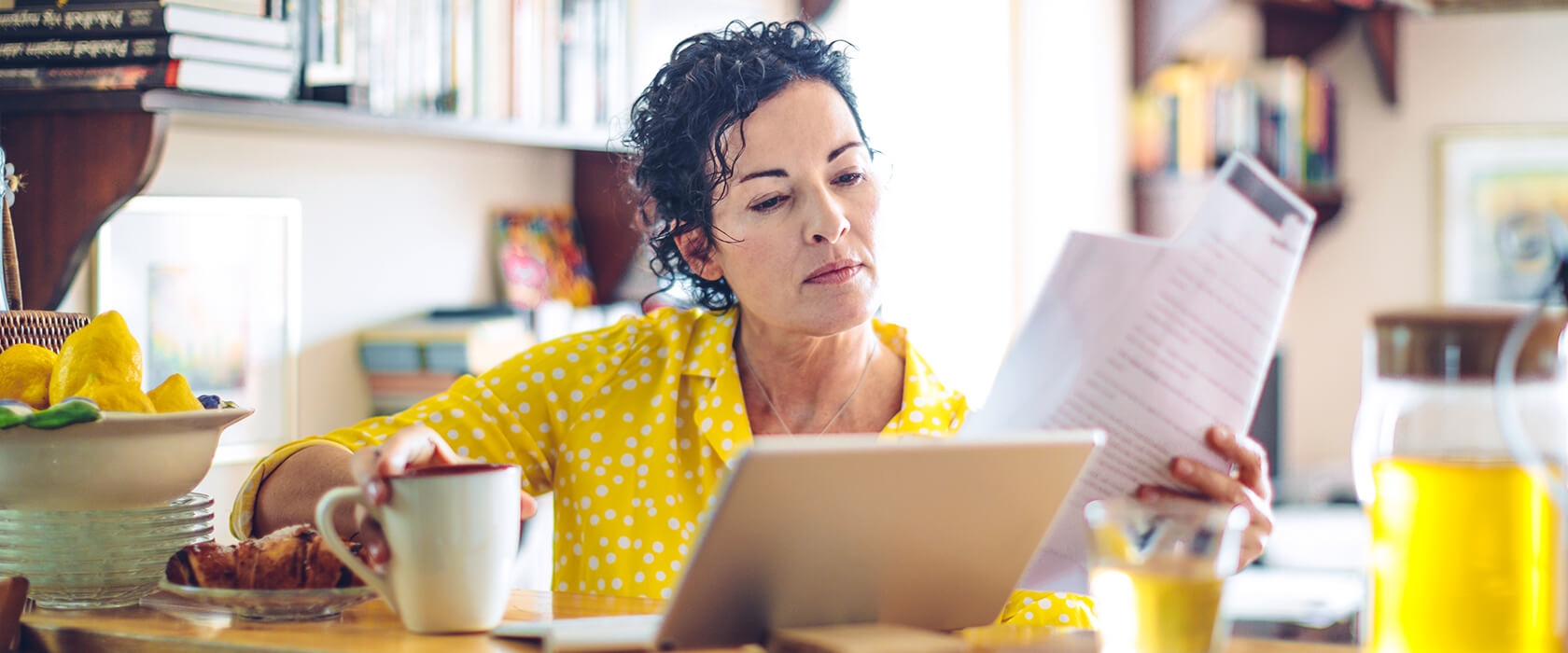 A woman reviews finances on laptop computer