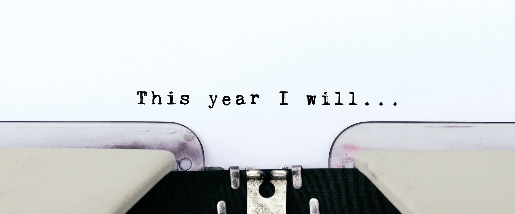 View of a new years resolution paper in typewriter, "This year I will"