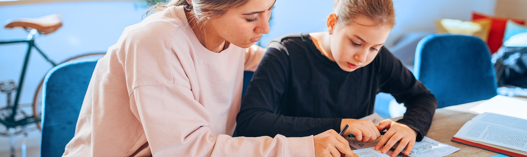 A mother and daughter work on homework