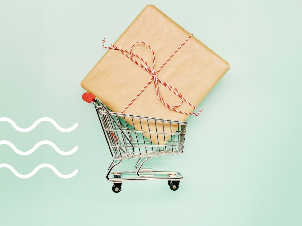 shopping cart carries large holiday gift box